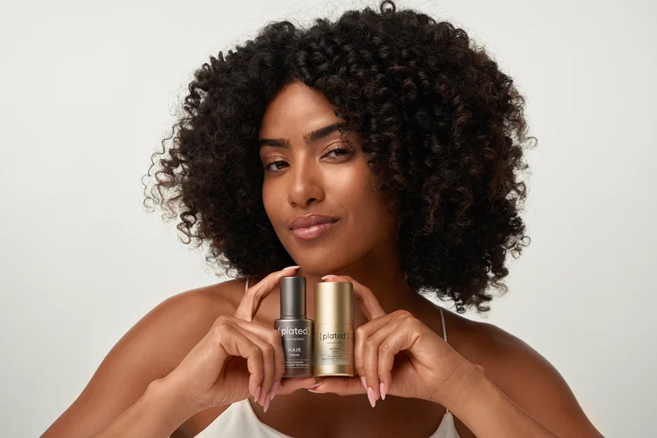 A patient holding (plated)® HAIR and INTENSE serums